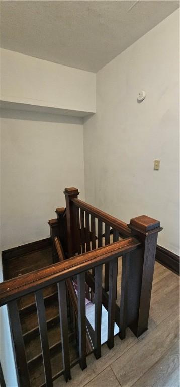 stairs featuring hardwood / wood-style floors