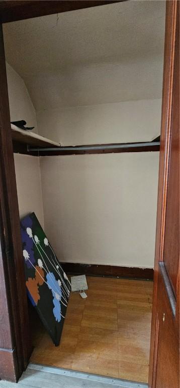 walk in closet with hardwood / wood-style flooring