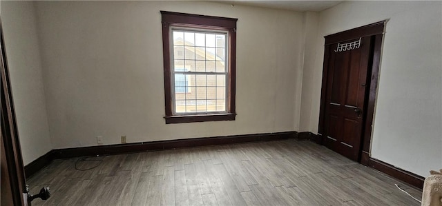 empty room with light hardwood / wood-style flooring