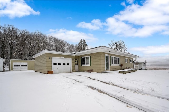 single story home with a garage and an outbuilding