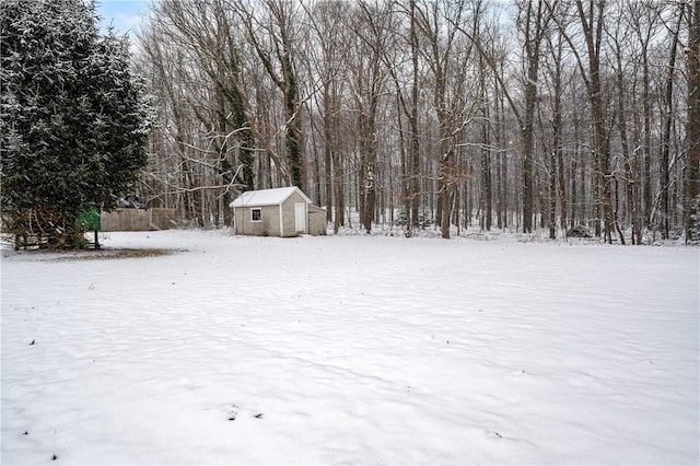 yard layered in snow with an outdoor structure