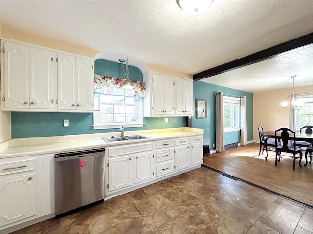 kitchen with dishwasher, sink, white cabinetry, and hanging light fixtures