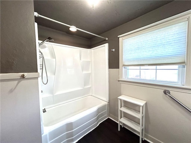 bathroom with hardwood / wood-style floors and tub / shower combination