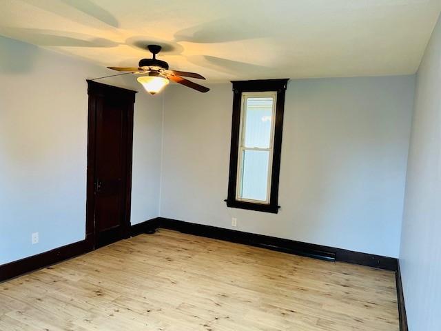 spare room with ceiling fan and light hardwood / wood-style flooring