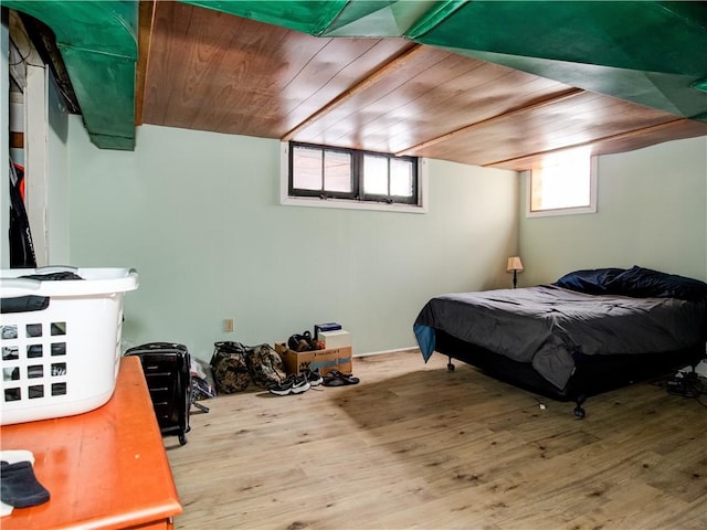 bedroom featuring wood ceiling and light wood-type flooring