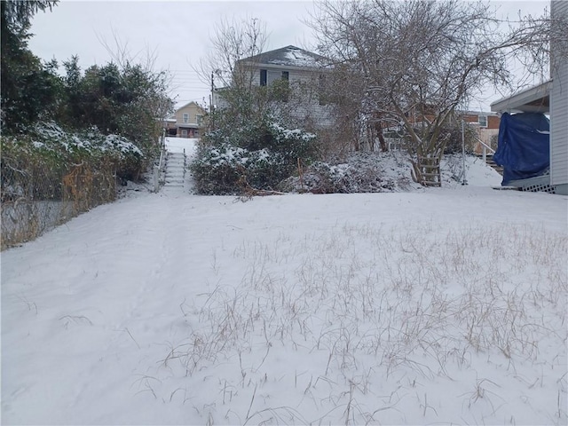 view of yard layered in snow