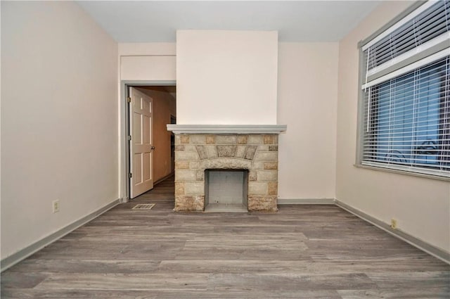 unfurnished living room with wood-type flooring and a fireplace