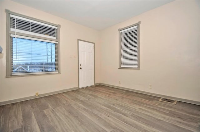 unfurnished room featuring wood-type flooring