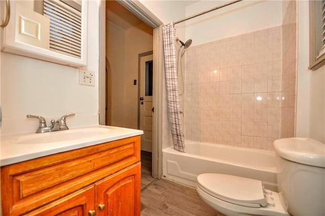 full bathroom featuring vanity, toilet, wood-type flooring, and shower / tub combo with curtain