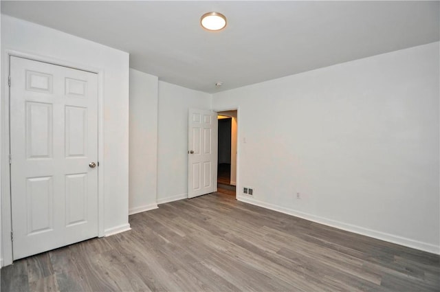 unfurnished bedroom featuring wood-type flooring