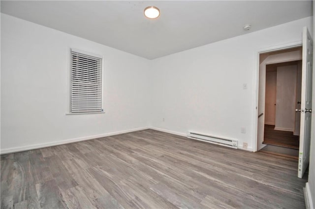 spare room with hardwood / wood-style flooring and baseboard heating