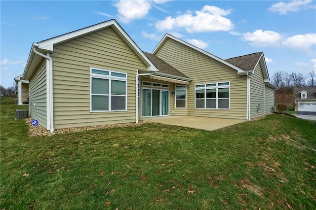 rear view of property with central AC unit, a patio area, and a lawn