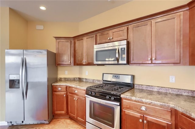 kitchen featuring light wood-type flooring and appliances with stainless steel finishes