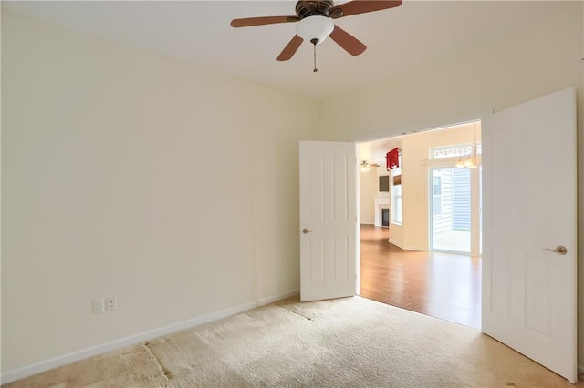 carpeted empty room featuring ceiling fan