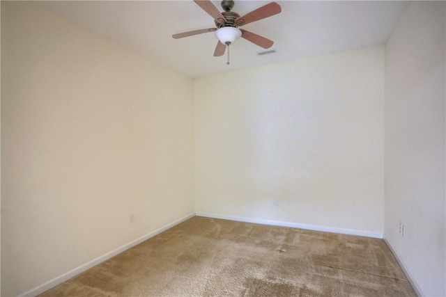 carpeted spare room featuring ceiling fan