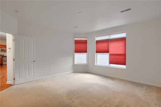 unfurnished room with light carpet