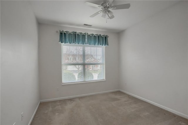 unfurnished room featuring ceiling fan and light carpet