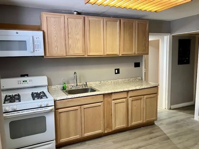 kitchen featuring light wood-type flooring, light brown cabinetry, white appliances, and sink