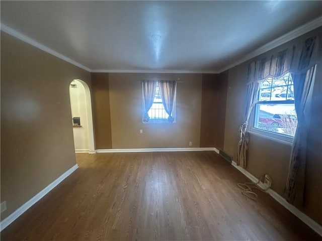 unfurnished room featuring ornamental molding and hardwood / wood-style flooring