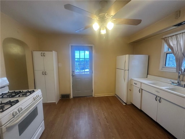 kitchen with white cabinetry, sink, ceiling fan, white appliances, and hardwood / wood-style flooring