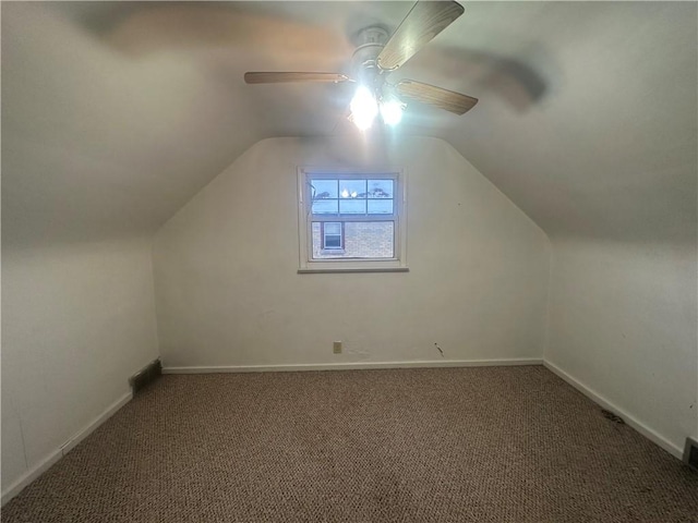 additional living space featuring carpet flooring, vaulted ceiling, and ceiling fan