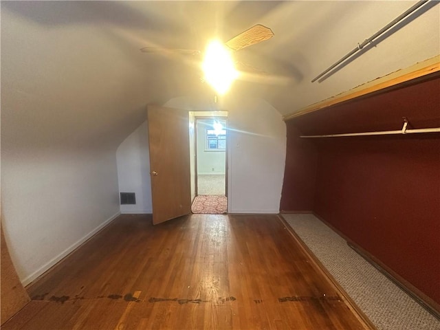 bonus room with vaulted ceiling, ceiling fan, and dark wood-type flooring