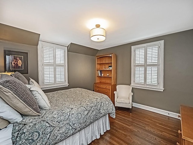 bedroom with lofted ceiling and dark hardwood / wood-style floors