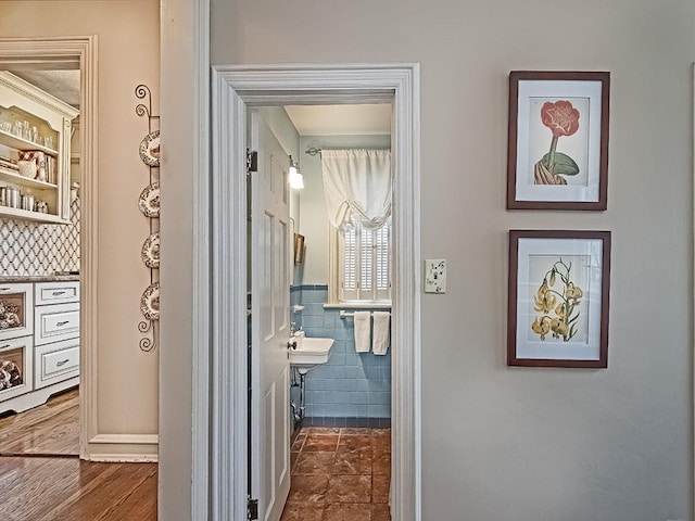 hallway with tile walls