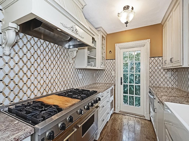 kitchen with premium range hood, backsplash, light stone counters, and dark hardwood / wood-style flooring