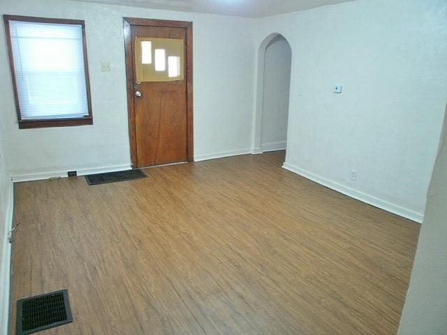 unfurnished room with hardwood / wood-style floors