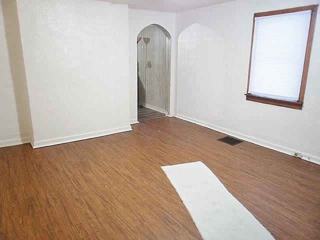 spare room with dark wood-type flooring