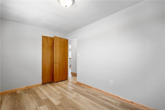 unfurnished room with light wood-type flooring