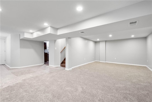 basement featuring light colored carpet