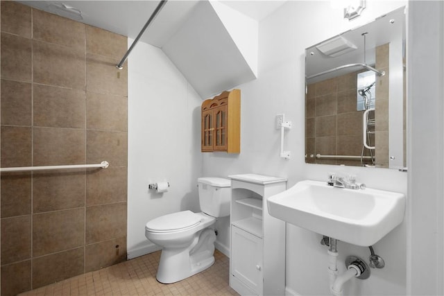 bathroom with tiled shower and toilet