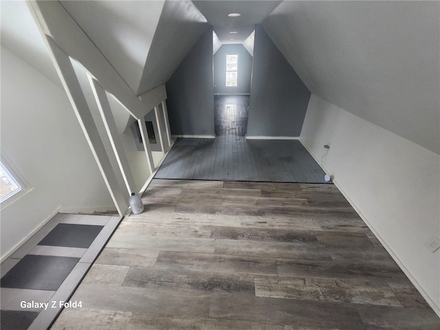 interior space with hardwood / wood-style floors and vaulted ceiling