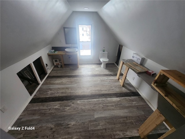 bonus room featuring dark hardwood / wood-style floors and vaulted ceiling