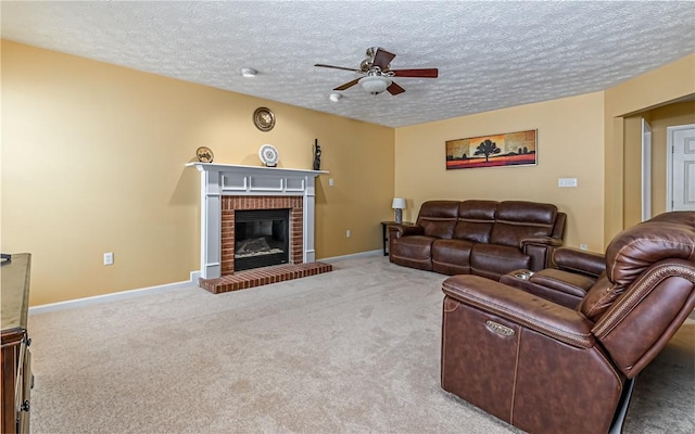 carpeted living room with ceiling fan, a fireplace, and a textured ceiling