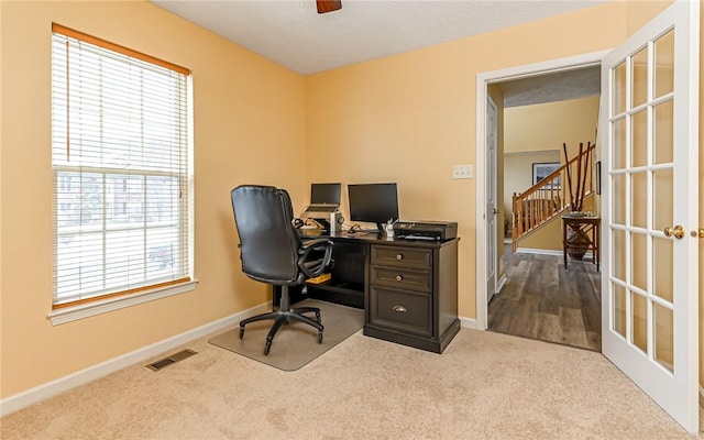 carpeted office space featuring french doors and a wealth of natural light