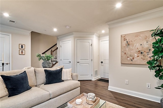 living room with dark hardwood / wood-style flooring and crown molding