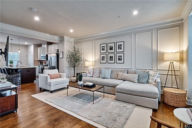 living room with dark hardwood / wood-style floors and crown molding