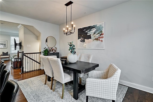 dining area featuring hardwood / wood-style flooring and a notable chandelier