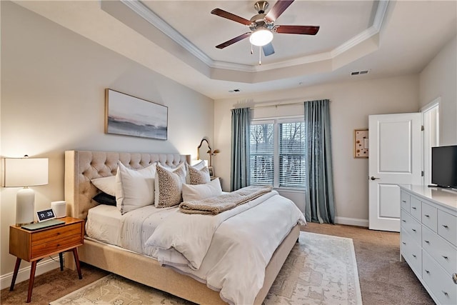 bedroom with light carpet, a raised ceiling, ceiling fan, and ornamental molding