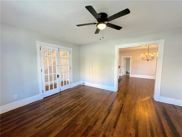 unfurnished room with french doors, ceiling fan with notable chandelier, and dark hardwood / wood-style floors