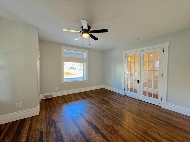 spare room with french doors, ceiling fan, and dark wood-type flooring