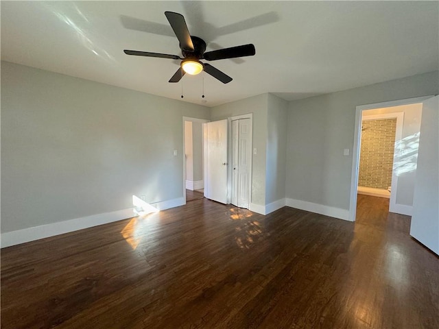 empty room with dark hardwood / wood-style floors and ceiling fan