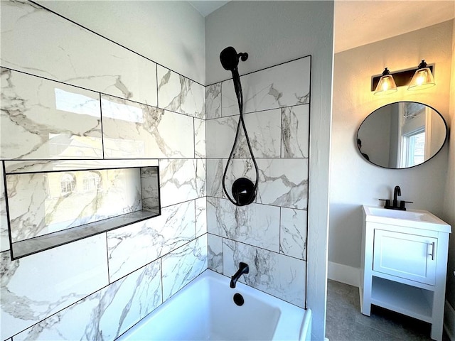 bathroom featuring tile patterned floors, vanity, and tiled shower / bath