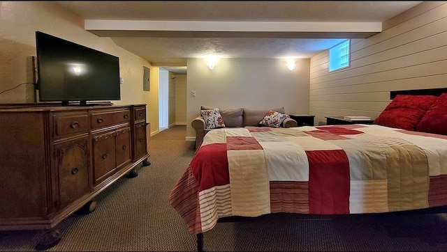 bedroom with dark colored carpet, beamed ceiling, and wood walls