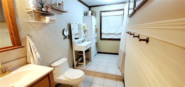 bathroom featuring tile patterned flooring, vanity, toilet, and ornamental molding