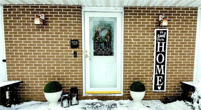 view of snow covered property entrance