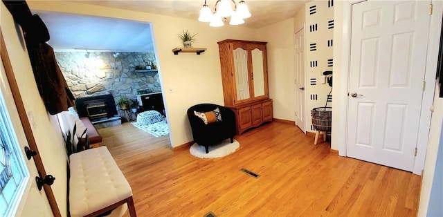 entrance foyer featuring light hardwood / wood-style flooring and a chandelier